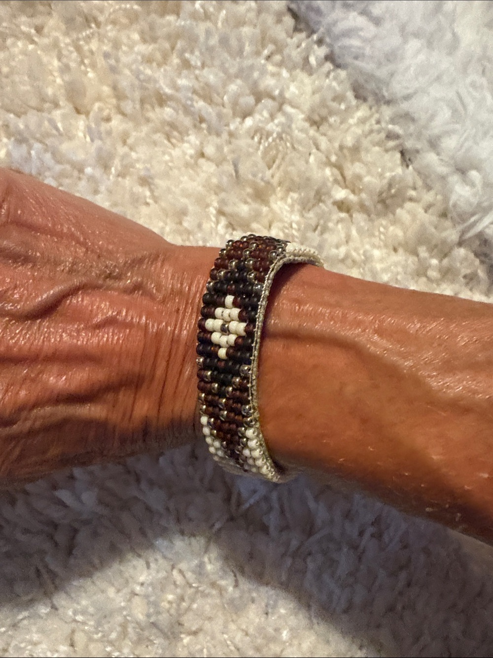Handcrafted Beaded Bracelet in Brown and White leather underneath